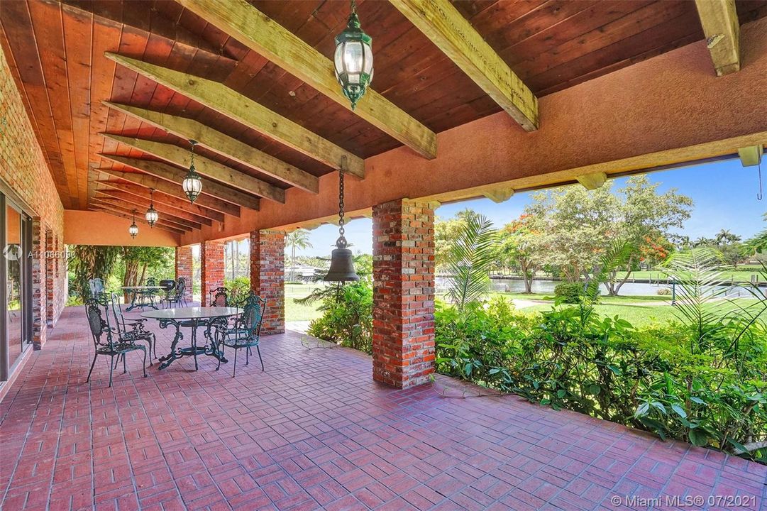 Gorgeous rear patio with extensive wood beam details and views of the waterway and yacht basin