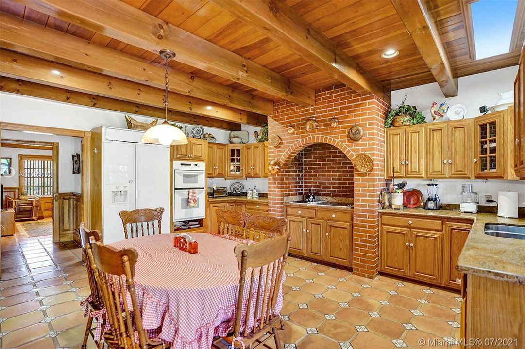 Extensive oak beam ceilings and brick work in the large eat-in kitchen