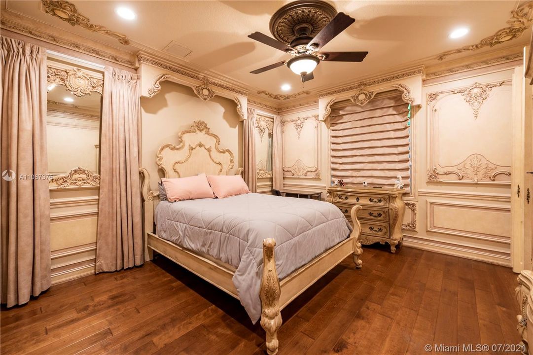 Professionally designed Victorian 2nd bedroom with wood flooring, walk-in closet, and en suite bathroom