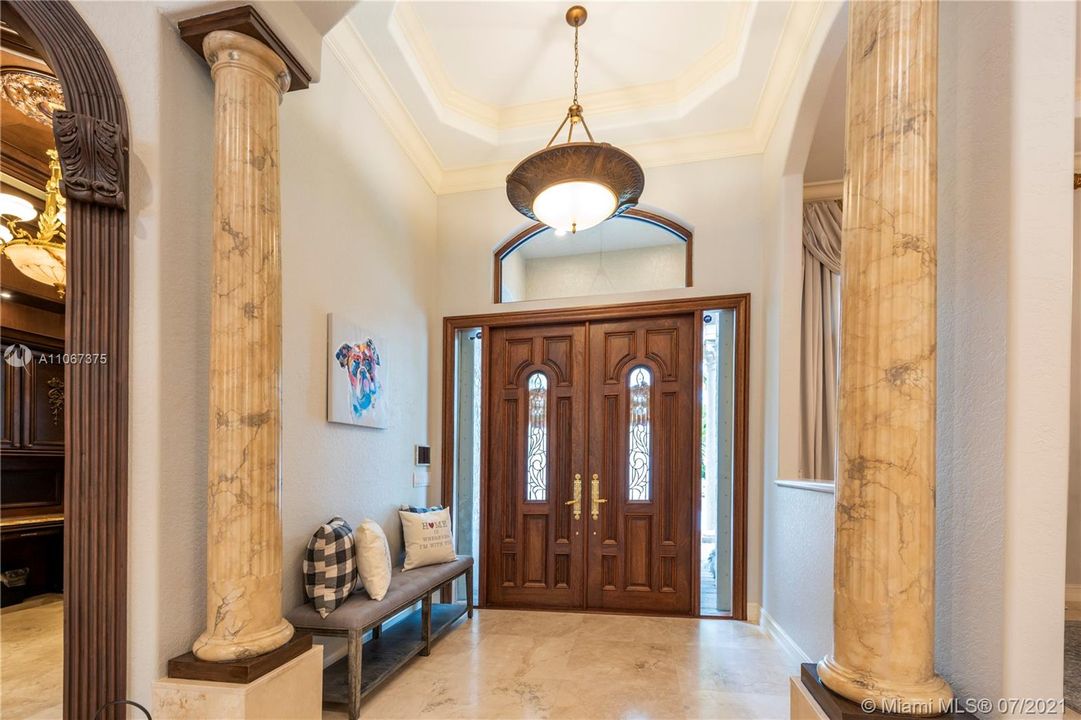 Stately foyer entry with coffered ceiling