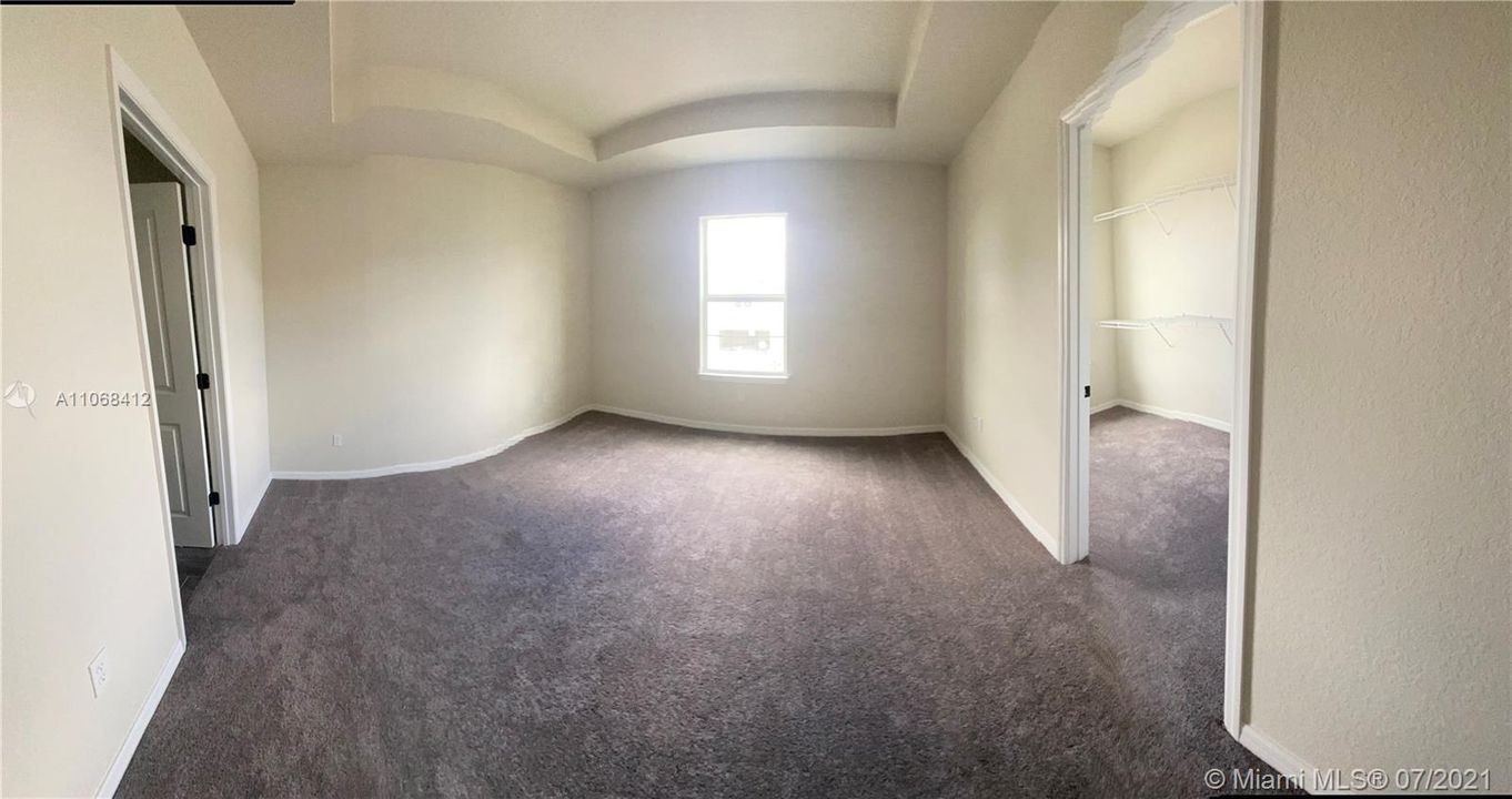 master bedroom/walk in closet with window