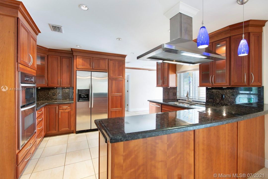 Large kitchen featuring Kitchen Aid stainless steel appliances and granite countertops.