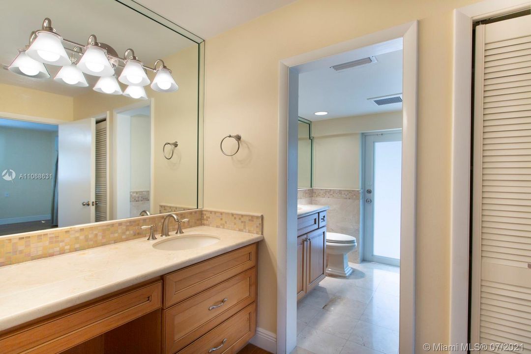 Bathroom with 2 separated sinks and counter space.