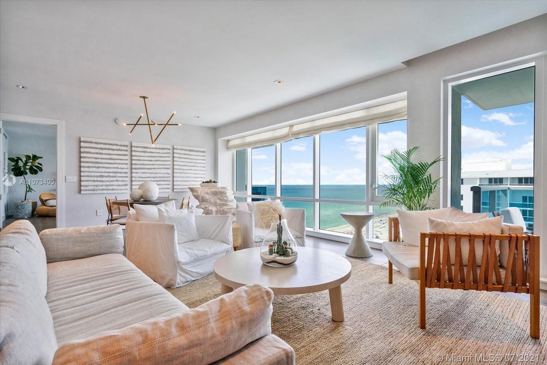 Living room with private balcony and views of the ocean, beach and 1 Hotel pools