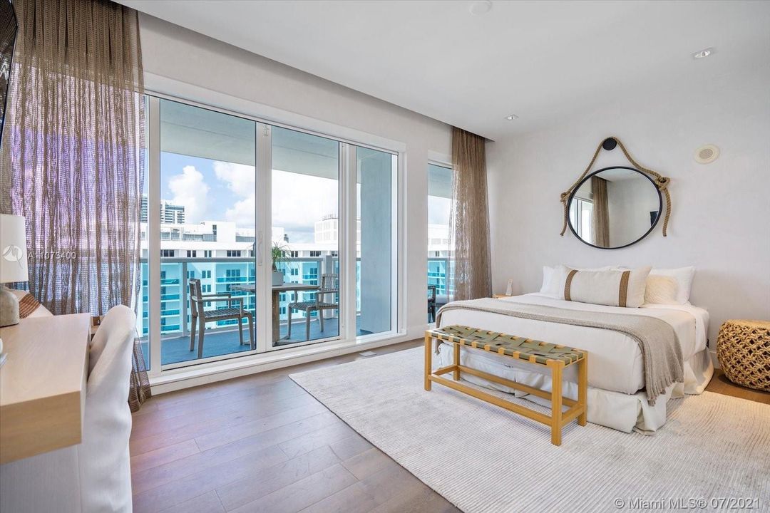 Third bedroom with balcony access and views of the ocean, beach and 1 Hotel pools
