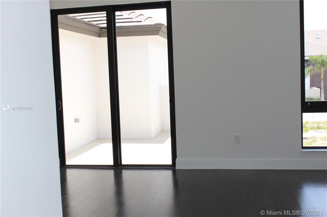 GLASS DOORS IN MASTER LEADING TO PRIVATE BALCONY