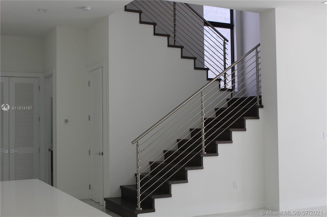 STAINLESS STEEL STAIR RAILING WITH WOOD STAIR CASE