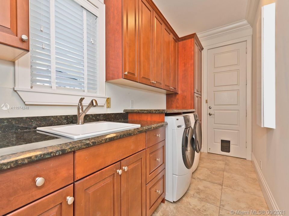 Full laundry room with Refrigerator and sink.