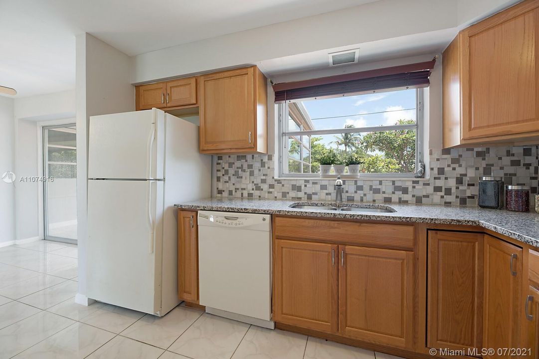 Kitchen overlooking fenced yard