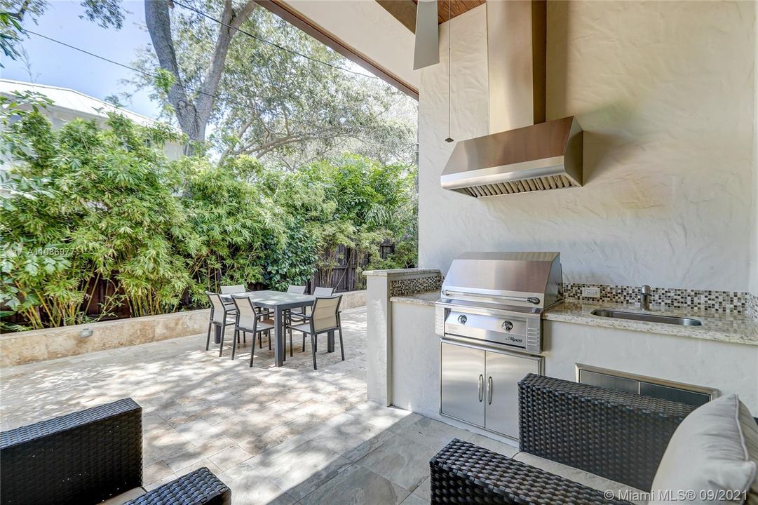 Summer Kitchen w/ sink, Grill plumbed w/ natural gas line to the street.