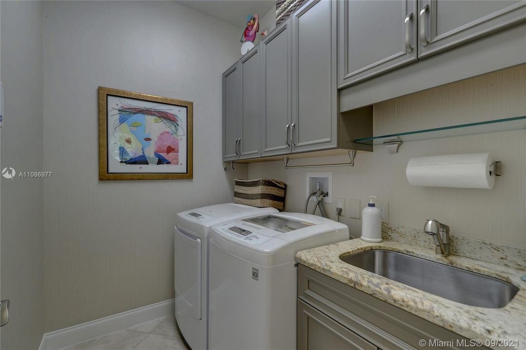 Large Laundry Room w/ Sink & Wood Cabinets / Granite + wall papered