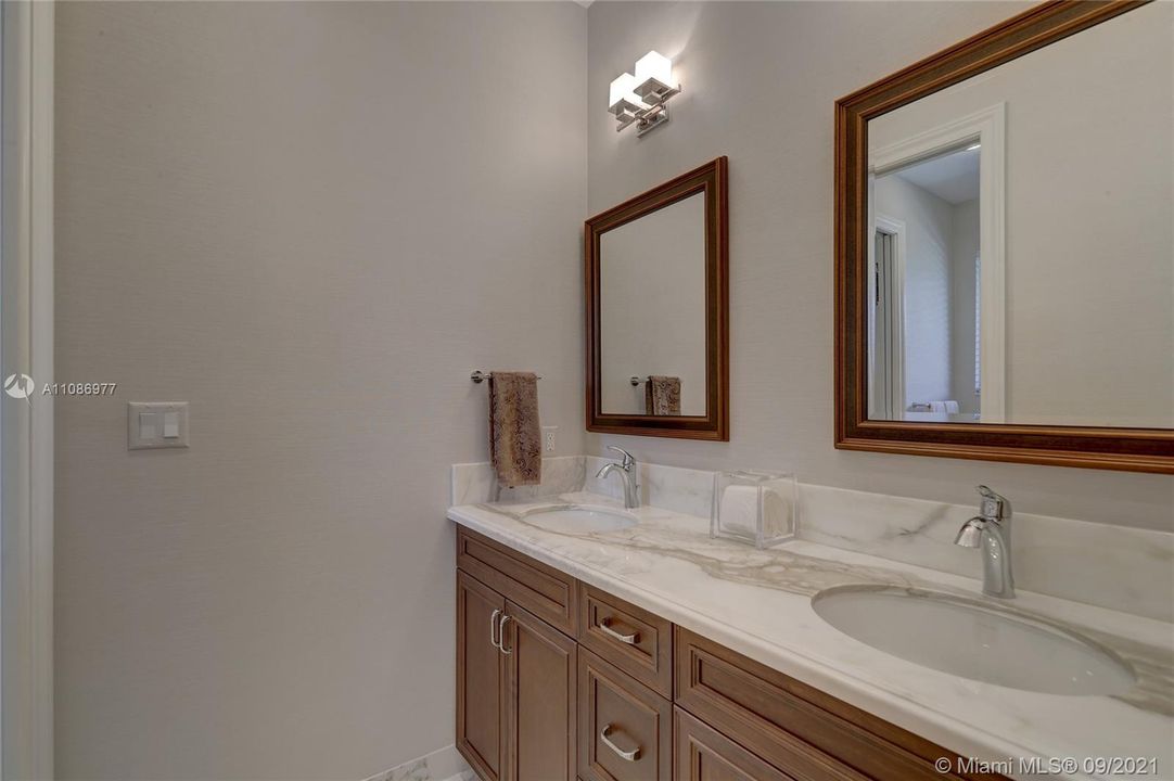 Dual Sinks, Marble Counters, Wood Cabinets. Separate room w/ shower & toilet.