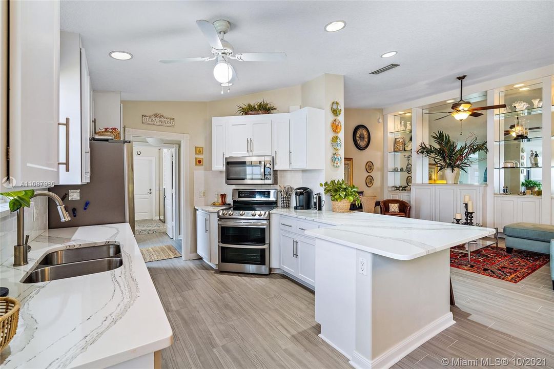 Updated Kitchen with Quartz countertops and new stainless steel appliances. Porcelain tile floors throughout.