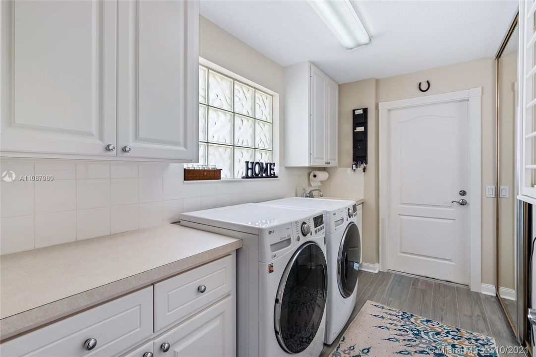 Laundry room with newer appliances and lots of storage.