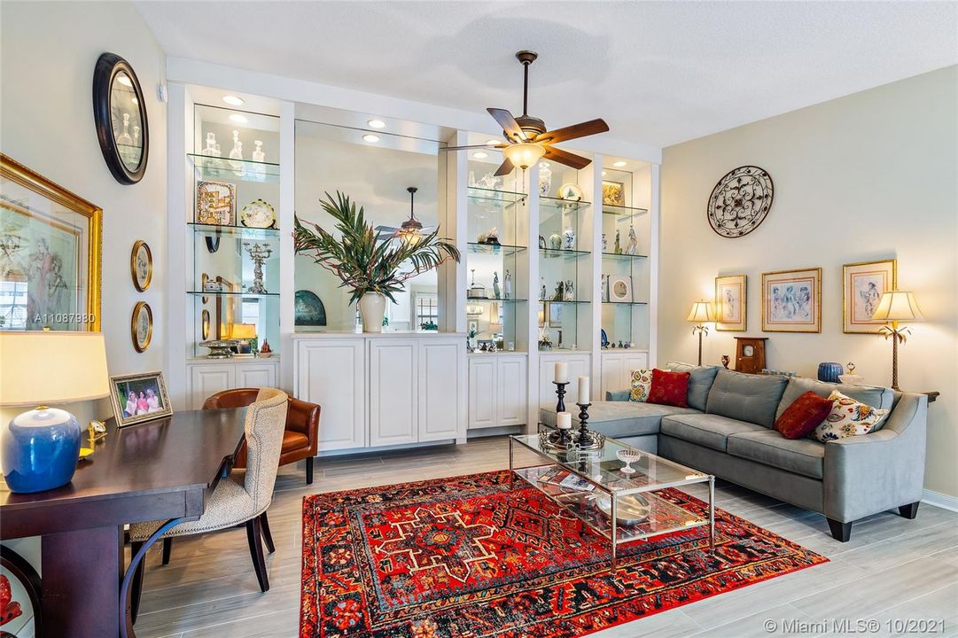 Living room with built in shelving. Porcelain tile floors throughout.