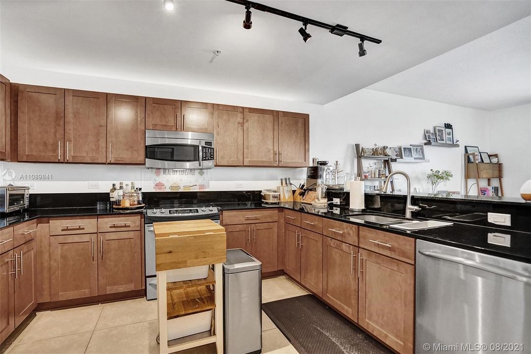 Beautifully appointed kitchen opens to dining room and enjoys views from long balcony