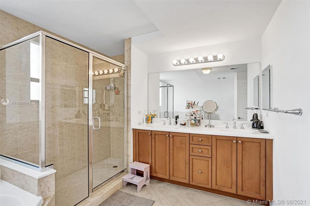 Luxury primary bathroom boasts roman tub and separate shower, and dual sinks