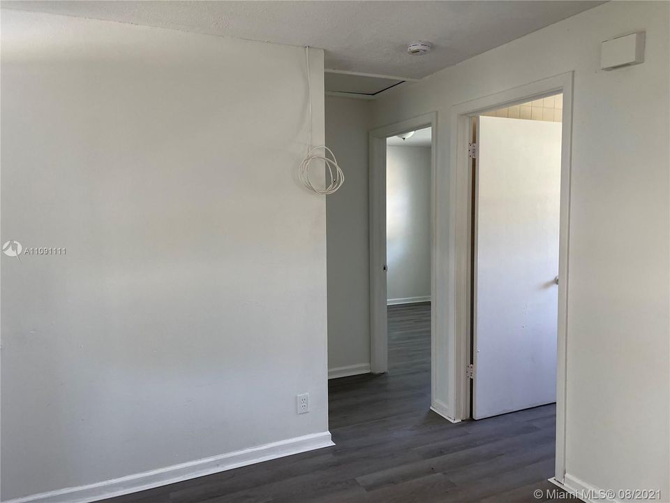 Hall into bedrooms on each side- bathroom is the first door on the right