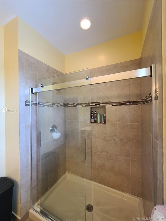 upgraded rolling glass doors in master bathroom shower