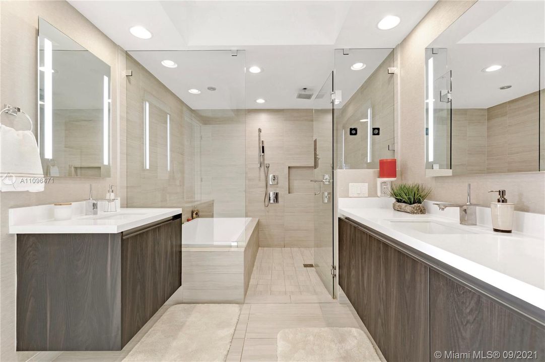 Dual Backlit Vanities and Spacious Shower / Tub Combo
