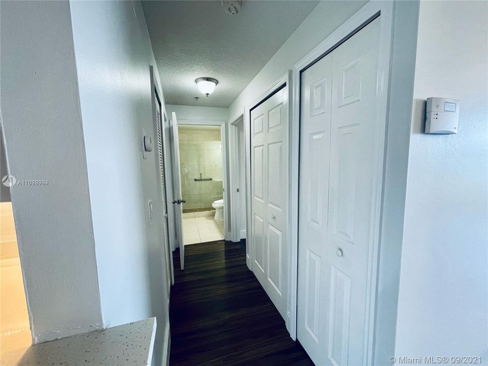 Hallway to second bathroom and 2 bedrooms