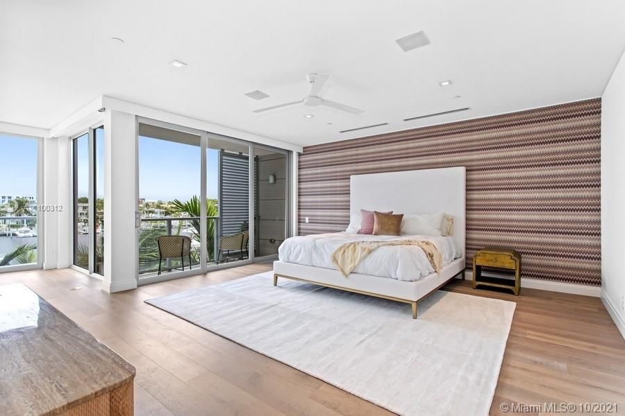 The Master Suite offers two walk-in-closets, spa inspired bathroom, and private balconies overlooking the marina where you can park your yacht.
