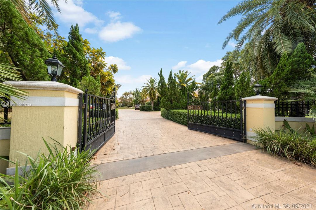 FROM THE EXTERIOR WALL AND CUSTOM GATES TO THE STATELY DRIVE IN SETS THE TONE FOR THIS ESTATE...