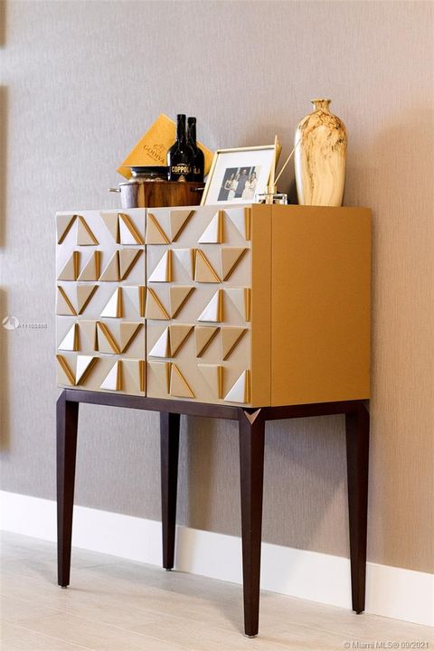 Detail gold lacquered design chest in dining room