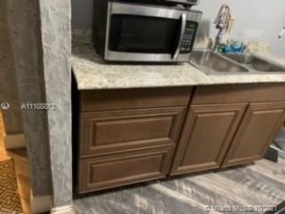 VIEW OF KITCHEN COUNTER TOP AND CABINET