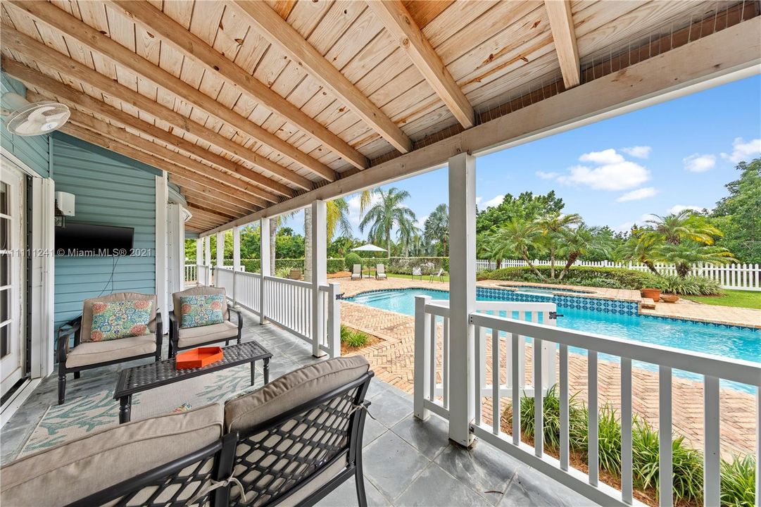 COVERED PORCHES WITH SITTING OVERLOOKING POOL DECK