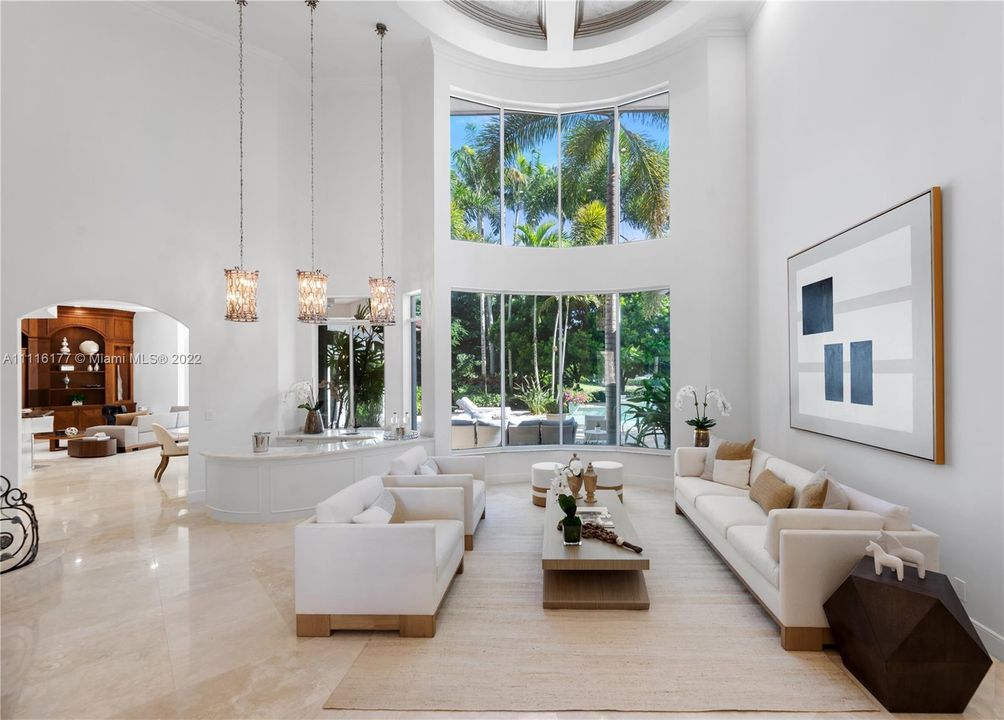 Soaring Volume 2 story Ceilings in the Living Room that overlooks the beautiful Pool area and Lush Gardens
