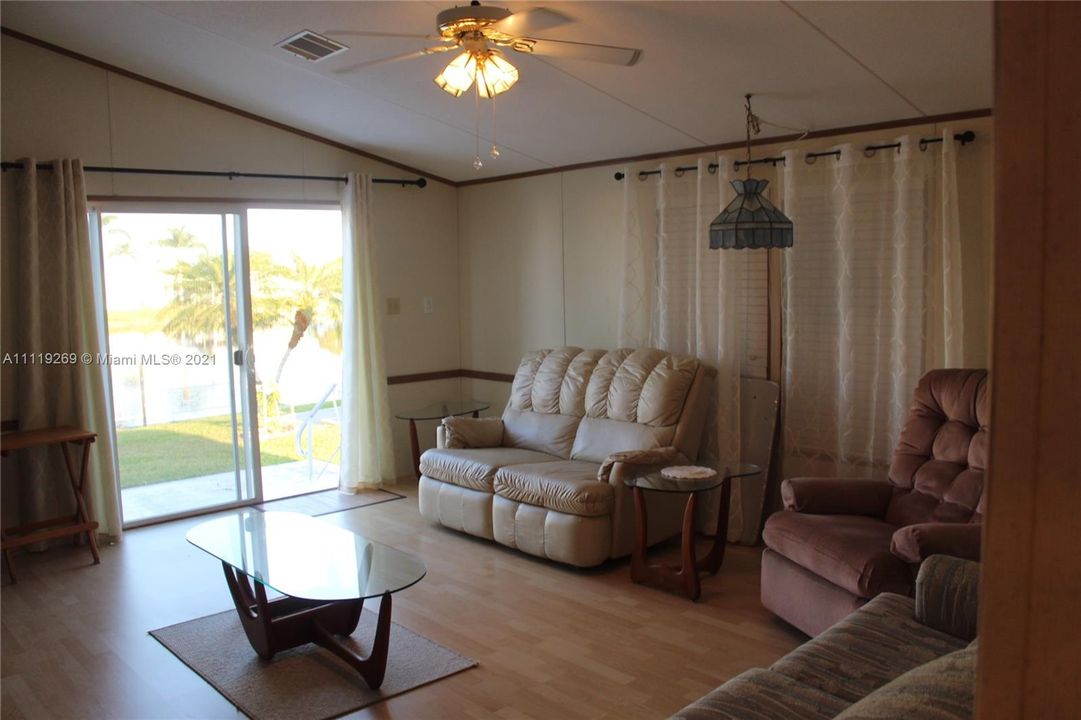 Living Room with sliding glass doors over  looking lake