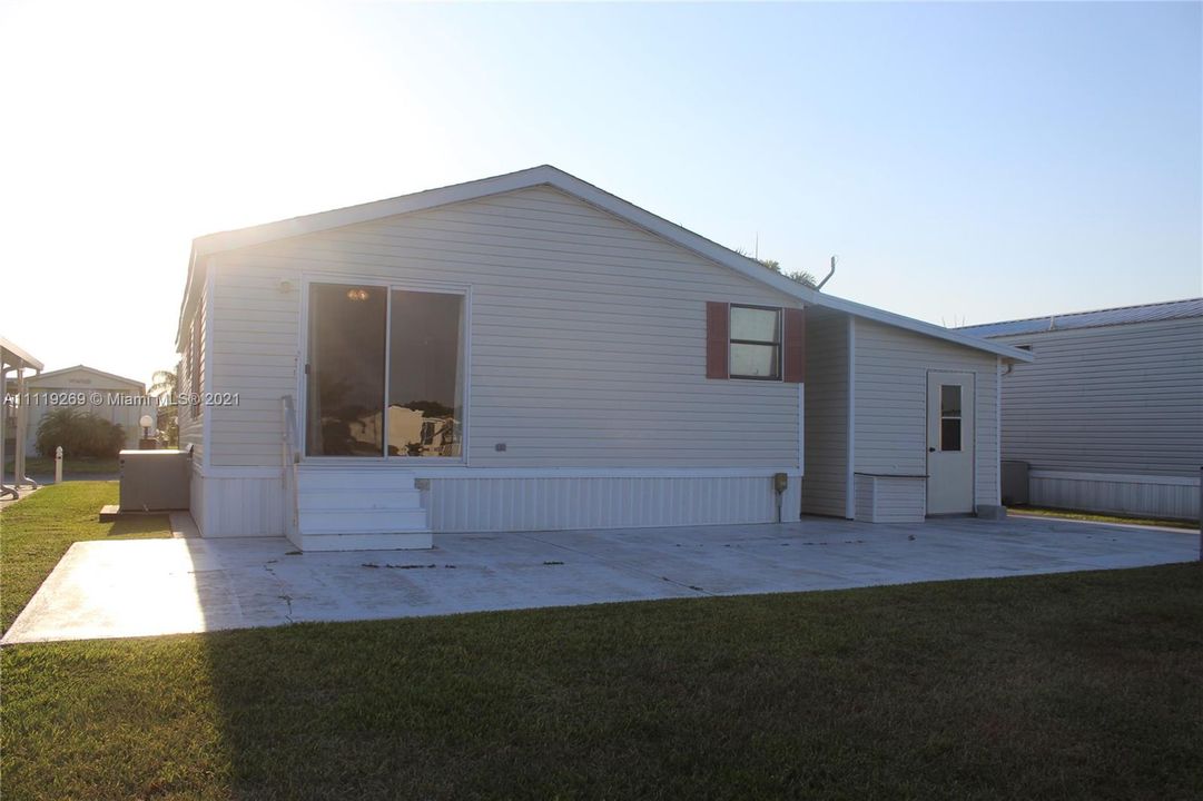 Back view with large concrete patio area