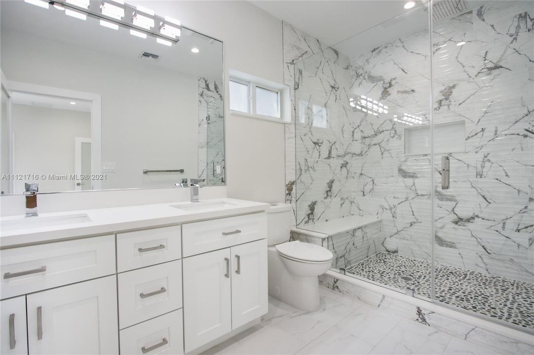 MASTER SUITE BATHROOM WITH DUAL SINKS AND GENEROUS RAIN SHOWER