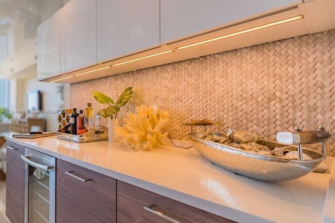 Bar with wine reserve and Travertine marble basketweave back splash