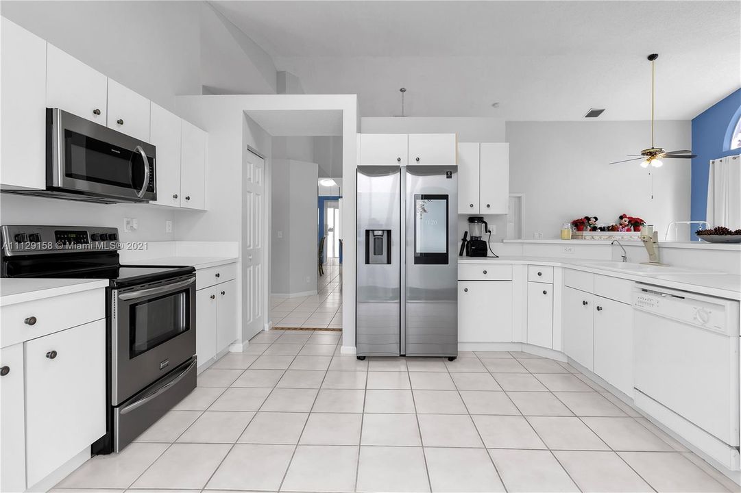 Spacious kitchen with newer smart refrigerator.