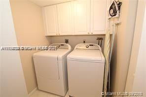 LAUNDRY ROOM WITH LINEN CLOSET/STORAGE CABINETS