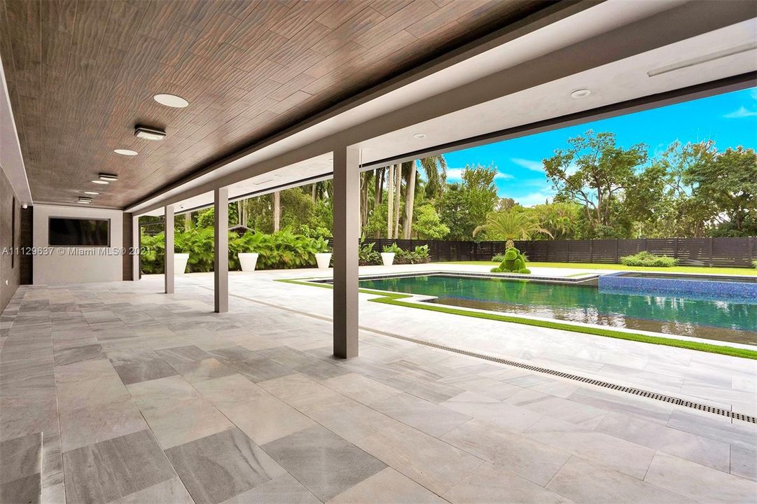 Backyard under covered patio with flat screen tvs