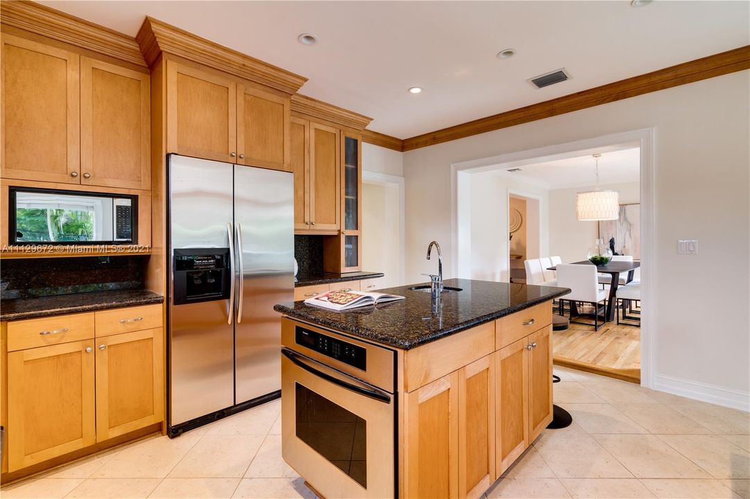 Kitchen features an adjacent walk-in pantry with extra refrigerator