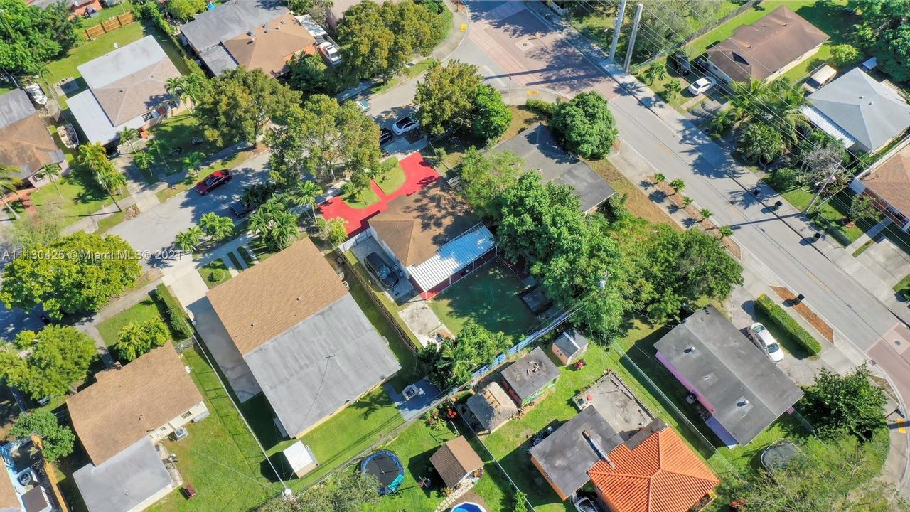 Aerial, red driveway, note, space to drive car behind gate into yard.