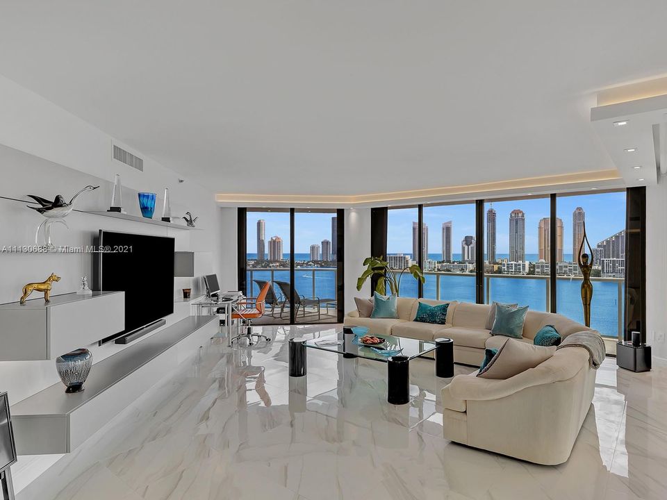 LIVING ROOM IS EXPANSIVE AND FEATURES A STUNNING WALL UNIT AND THE BEST VIEWS ON WILLIAMS ISLAND FROM THIS CORNER UNIT WITH 2100 SF.