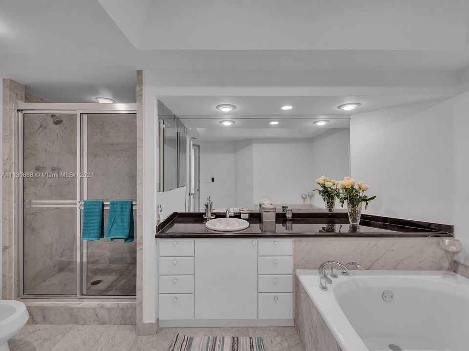 MARBLE ENSUITE BATHROOM IS LARGE AND LUXURIOUS.