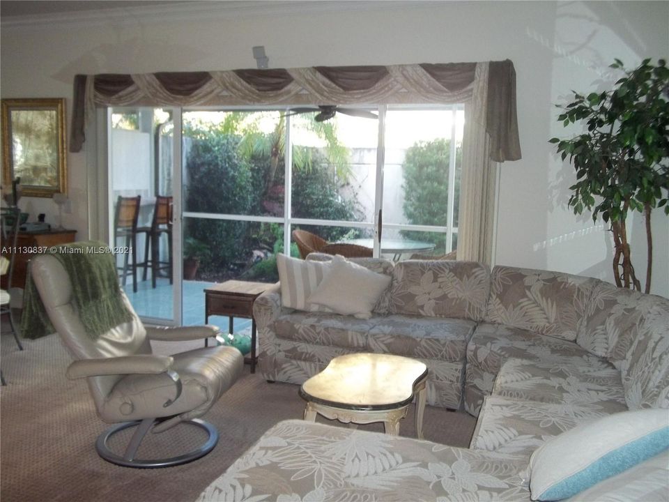 Great room opens onto screened & walled patio area.