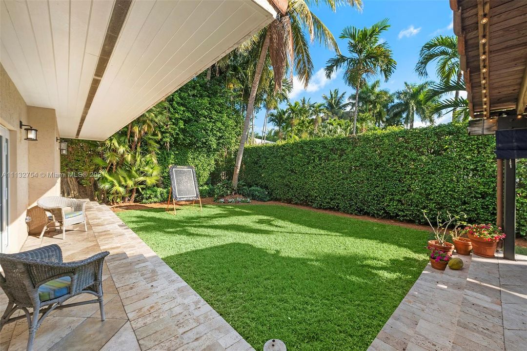 Private courtyard surrounded by lush greenery.
