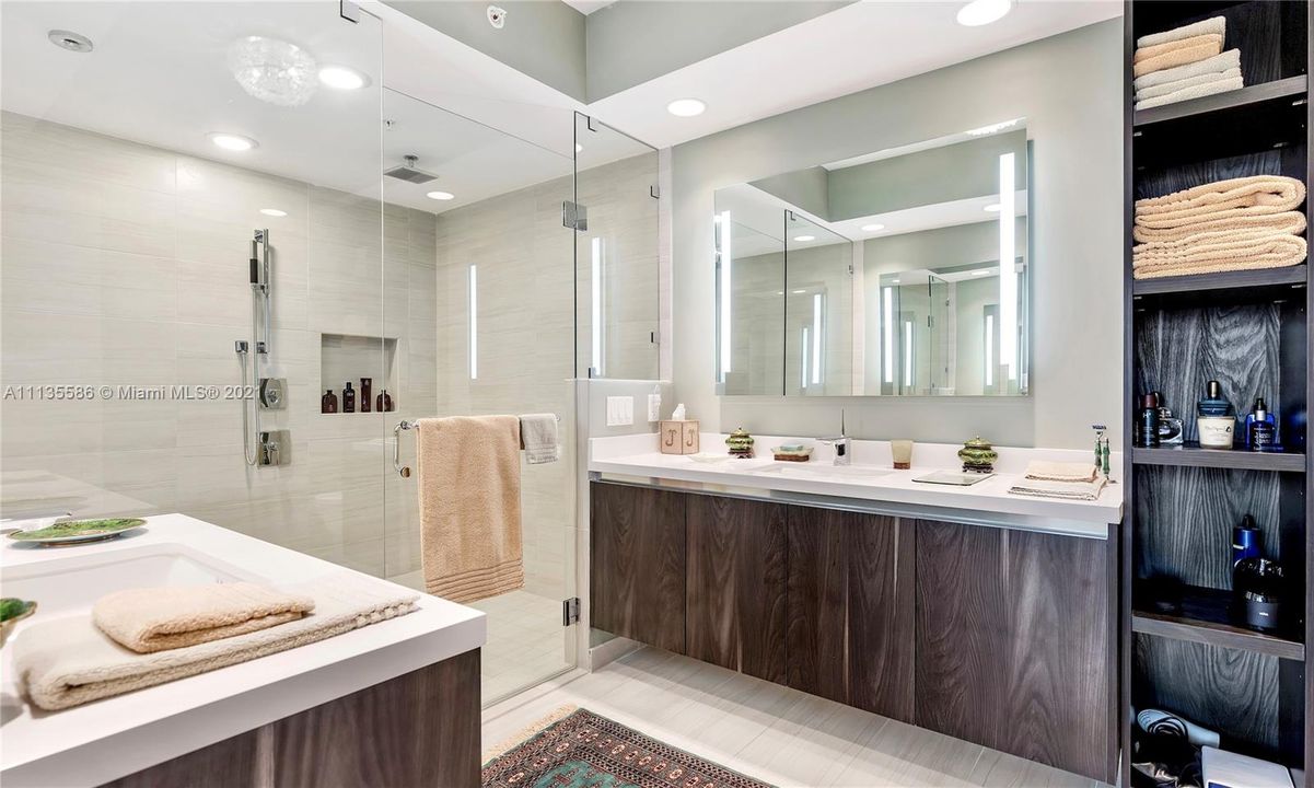 Primary Bath with Dual Back-Lit Vanities and Glass Enclosed Shower & Tub
