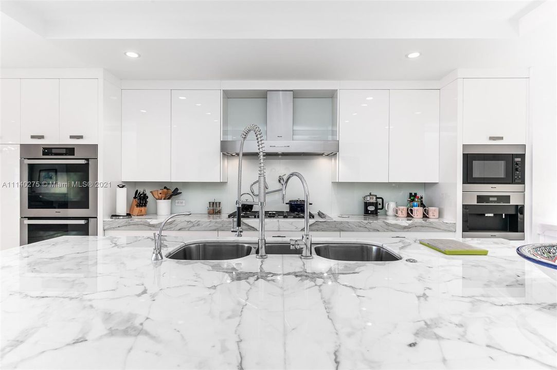 Chef's kitchen - marble countertops, Miele appliances, high gloss custom cabinets