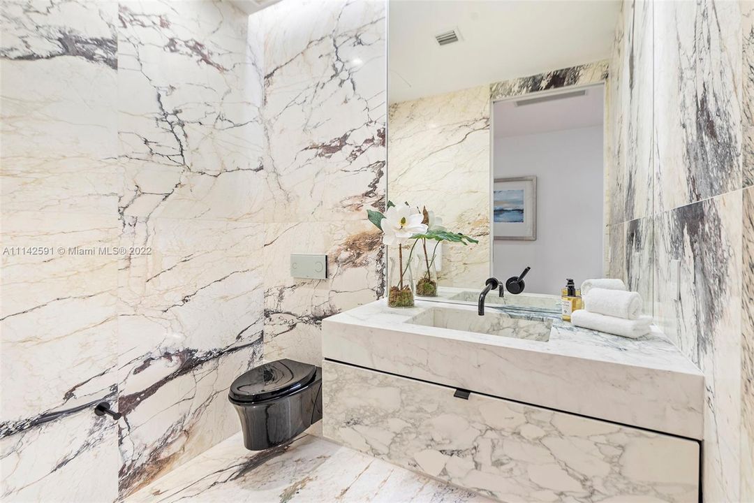 Gorgeous powder room with custom marble designs.