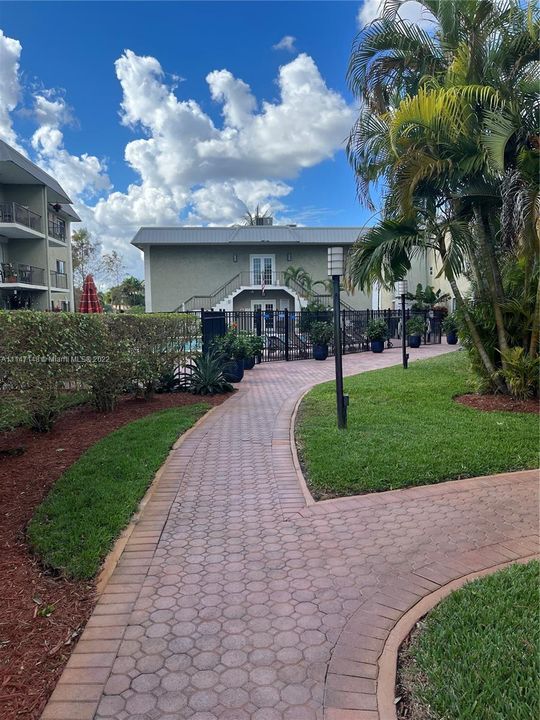 WALKWAY TO POOL, LUSH GARDEN