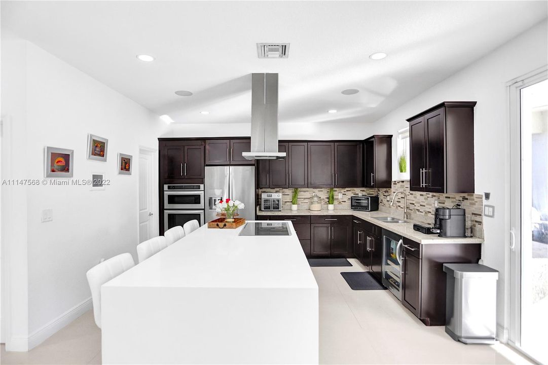 Kitchen has quartz countertop, separate walk-in pantry and wine cooler. SS appliances are Kitchen Aid