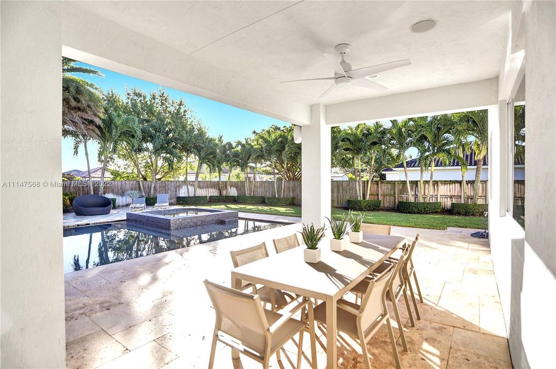 Wide covered patio offers respite from the Floridian sun and ample space for dining